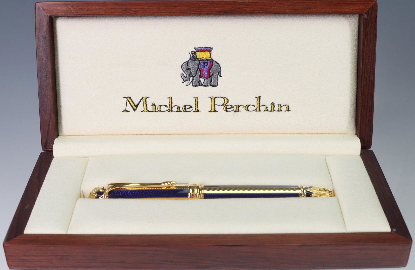 Michel Perchin Fountain Pen, 18k Nib: Michel Perchin Fountain Pen, gilt and blue enamel ribbed, 18k M Nib, original box included.