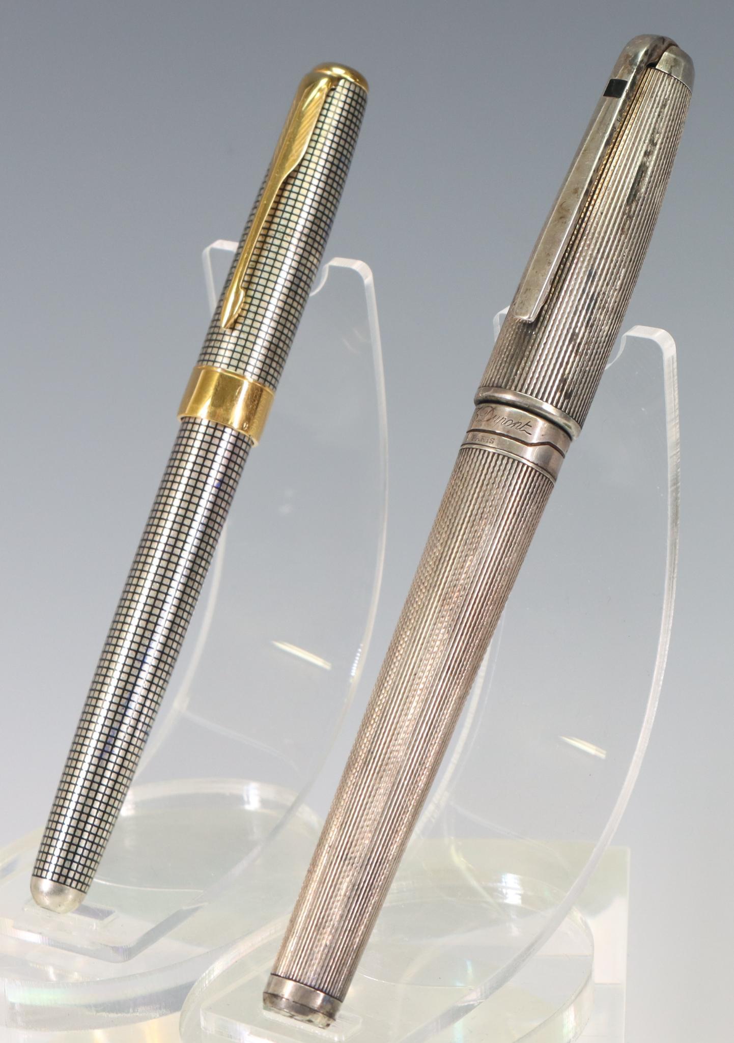 S.T. Dupont & Parker Ciselle Fountain Pens, 18k Nibs: S.T. Dupont Fountain Pen, silver ribbed finish, 18k M Nib, has been inked. Parker Ciselle Fountain Pen, sterling silver, 18k Nib.