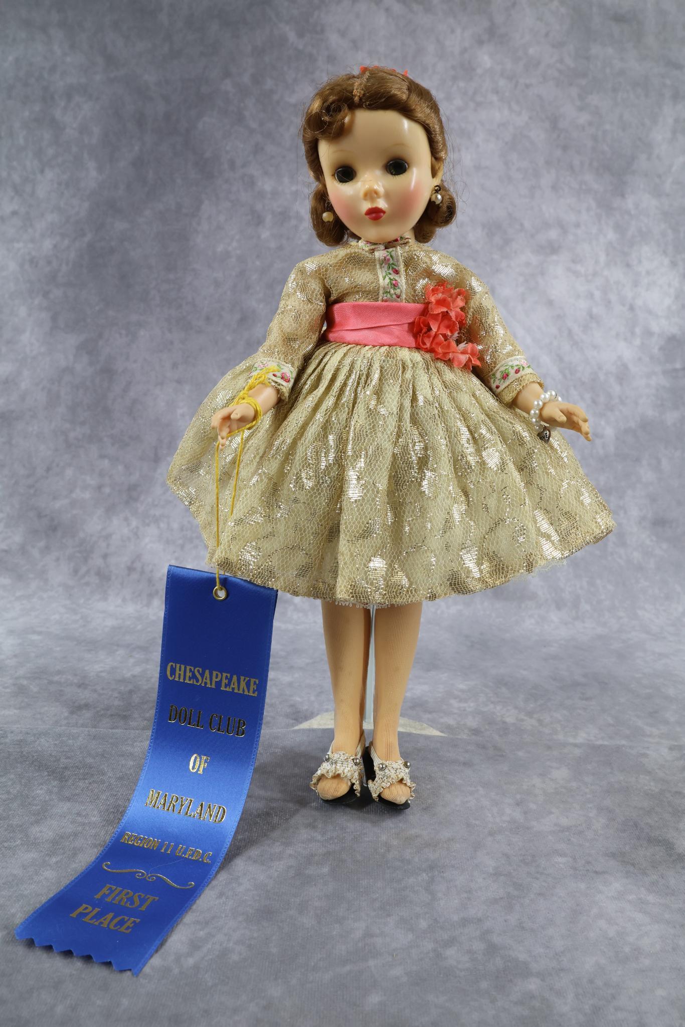 1940's-1960's DOLLS.: 14" 1958-1959 MADAME ALEXANDER "Shari Lewis" celebrity doll. Beautiful uncombed red hair. Dressed in original tagged gold lace dress. Petticoat, panties, nylons, HH shoes. Condition: age spots/discolo