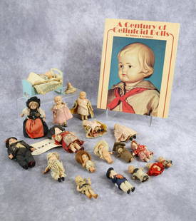 MINIATURES/DOLLS.: MINIATURES - DOLLS/BOOK. Antique. Lot of celluloid dolls and book. Dolls - Kewpies. Alsace couple. French couple in a 1939 New York World's Fair box. Babies, (1) in cradle. Condition: age loss,