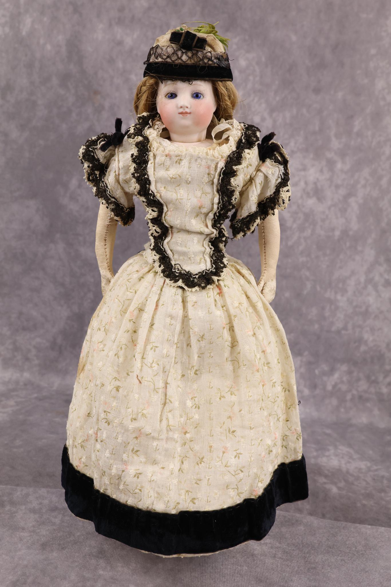 FRENCH FASHION DOLL.: 12" Unmarked (E Barrois?) Fashion doll with swivel neck, bisque shoulder plate (If marked, under leather body). Blue paper weight eyes, closed mouth, honey blonde human hair wig. Pink leather body wit