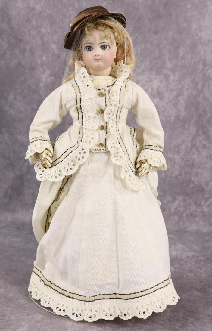 FRENCH FASHION DOLL.: 14" "2" (Jumeau) Fashion doll with swivel neck, unmarked bisque shoulder plate. Blue spiral paper weight eyes, closed mouth, pierced ears, long curly golden blonde mohair wig. Leather gusseted body wi