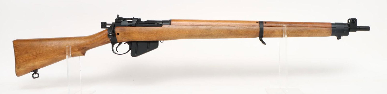 Enfield/CAI Unissued No4 MKII Bolt Action Rifle: 303 Britt, 25" bbl, SN UF 55 A7044. 98% black paint finish, very good bore, flip up rear peep/ladder style sight with guarded front, wood stock and handguards show only storage marks with newspaper ad