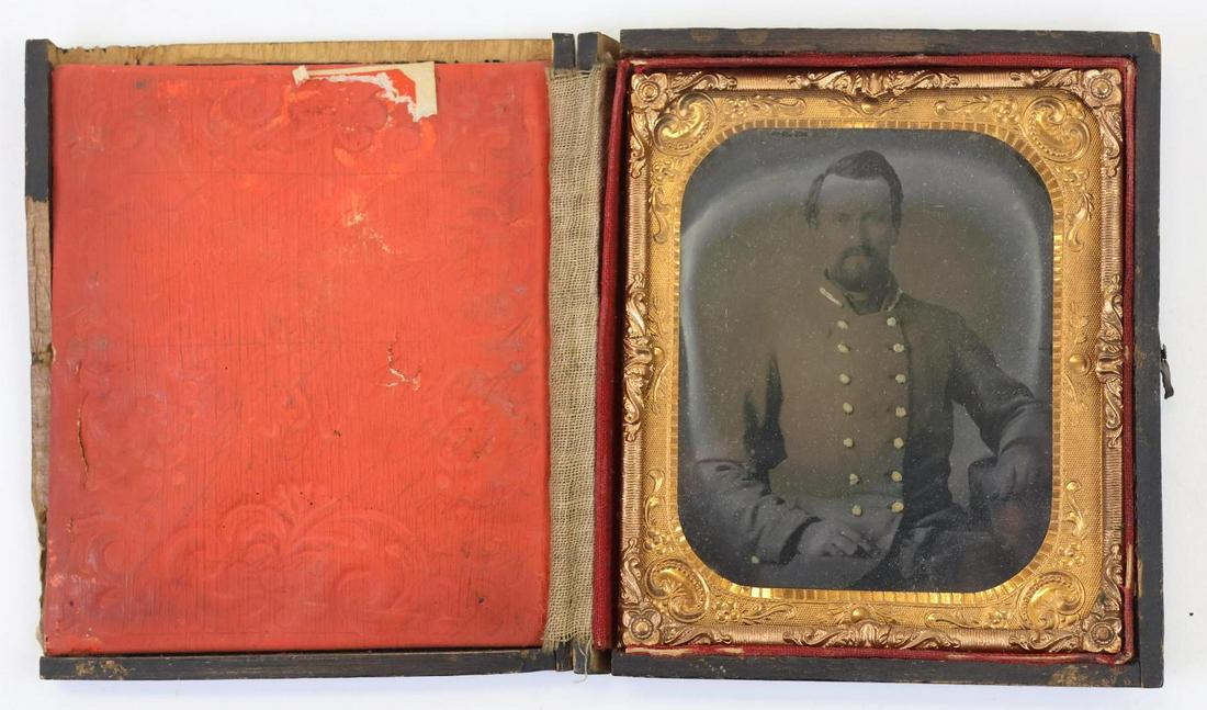 Civil War Confederate Officer-Ambrotype: Sixth plate ambrotype of an unidentified Confederate 2nd lieutenant, seated, knees up shot showing officer in uniform. Image exhibits some solarization and is housed in a damaged leatherette case. Pro