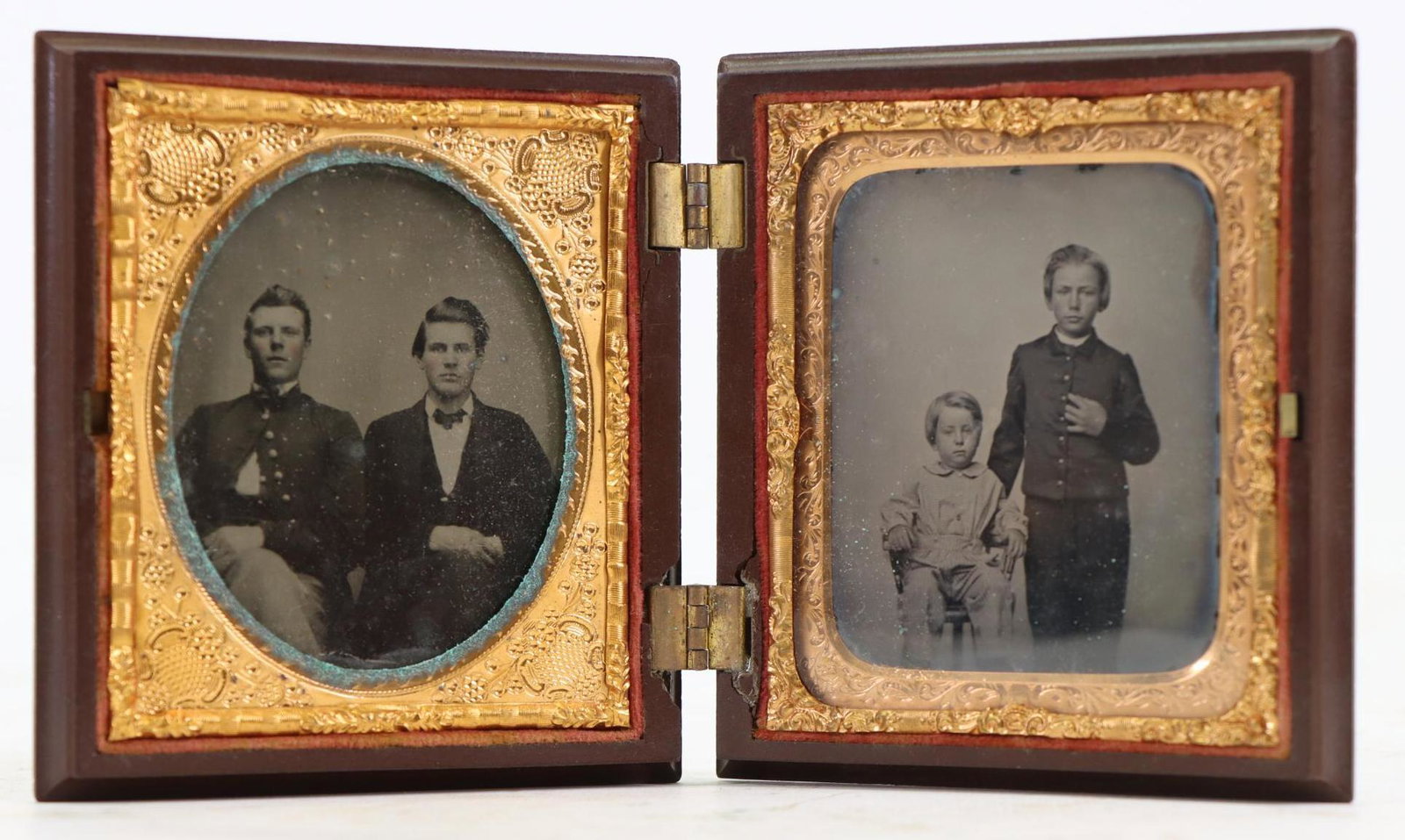 Civil War Soldier-Ambrotype: Pair of sixth plate ambrotypes being; 1.) Knees-up portrait of soldier wearing uniform seated next to friend/relative. 2.) Standing boy in cadet style uniform next to seated boy. Images are housed in 
