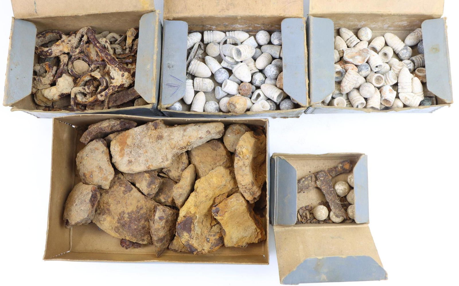 Collection of Excavated Civil War Relics: Collection of excavated Civil War relics contained in old museum style storage boxes. Boxes include: 1.) Box measuring 4" x 6.25" x 2.75" with ink title on top "Five Forks Chanc". Box contains variety