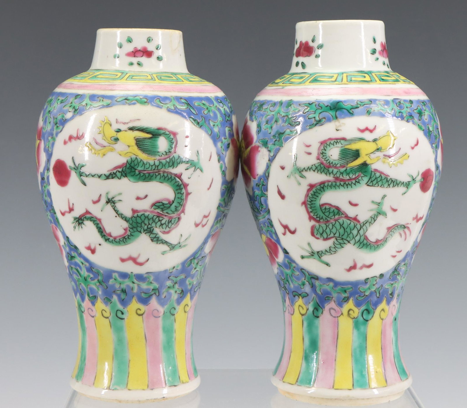 Chinese Famille Rose Vases: Pair of Chinese famille rose vases decorated with dragons chasing the flaming pearl. No covers 7.5"h x 4"round â€‹â€‹â€‹â€‹â€‹â€‹â€‹**Please Note: In-house shipping 