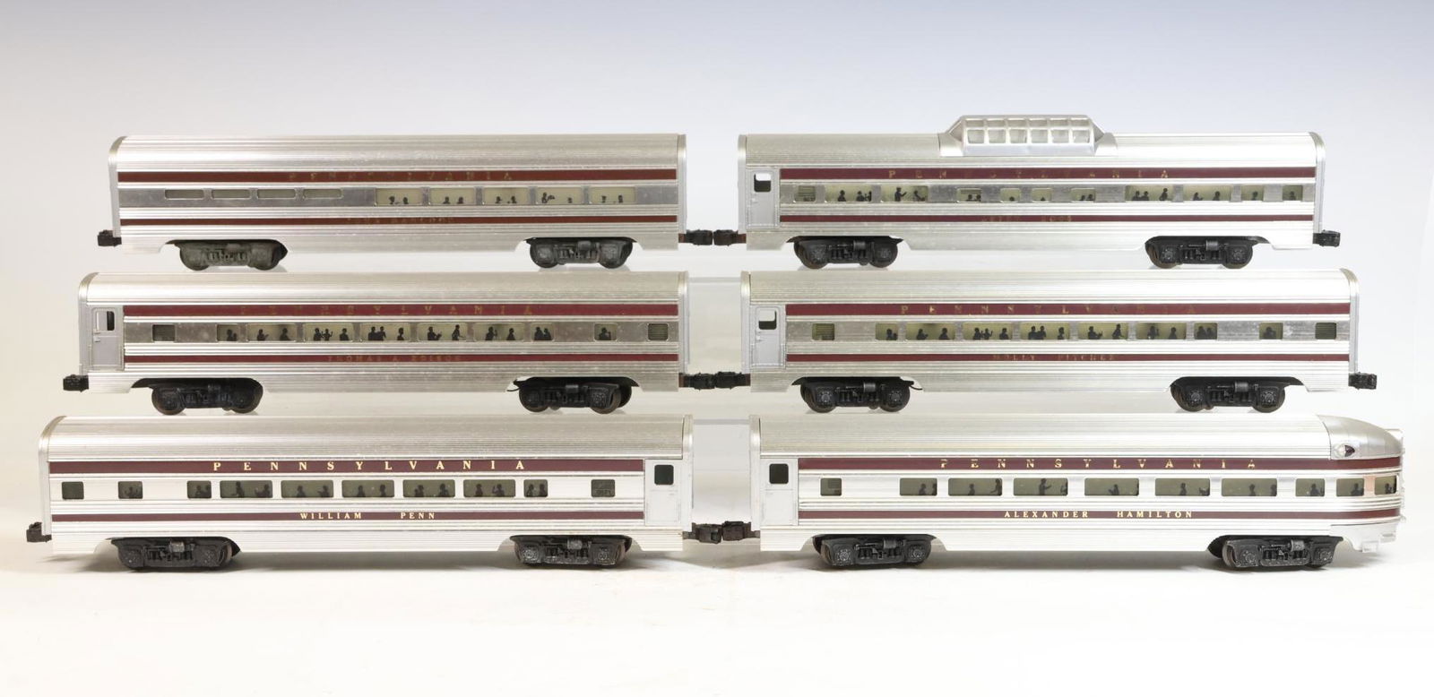 Lionel Pennsylvania Passenger Cars: O Gauge, 3-rail PRR aluminum passenger cars including #9571 William Penn coach, #9572 Molly Pitcher coach, #9573 Betsy Ross vista dome car, #9574 Alexander Hamilton coach, #9575 Thomas A. Edison coach