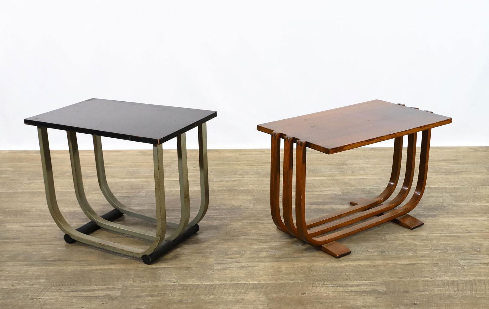 Art Deco Side Tables by Van Sciver and Century: Complementing side/occasional tables with triple U-form bases, including a black and silver painted example by J.B. Van Sciver, and a walnut example by Century. Surface wear and minor loss. 20"h x 24"