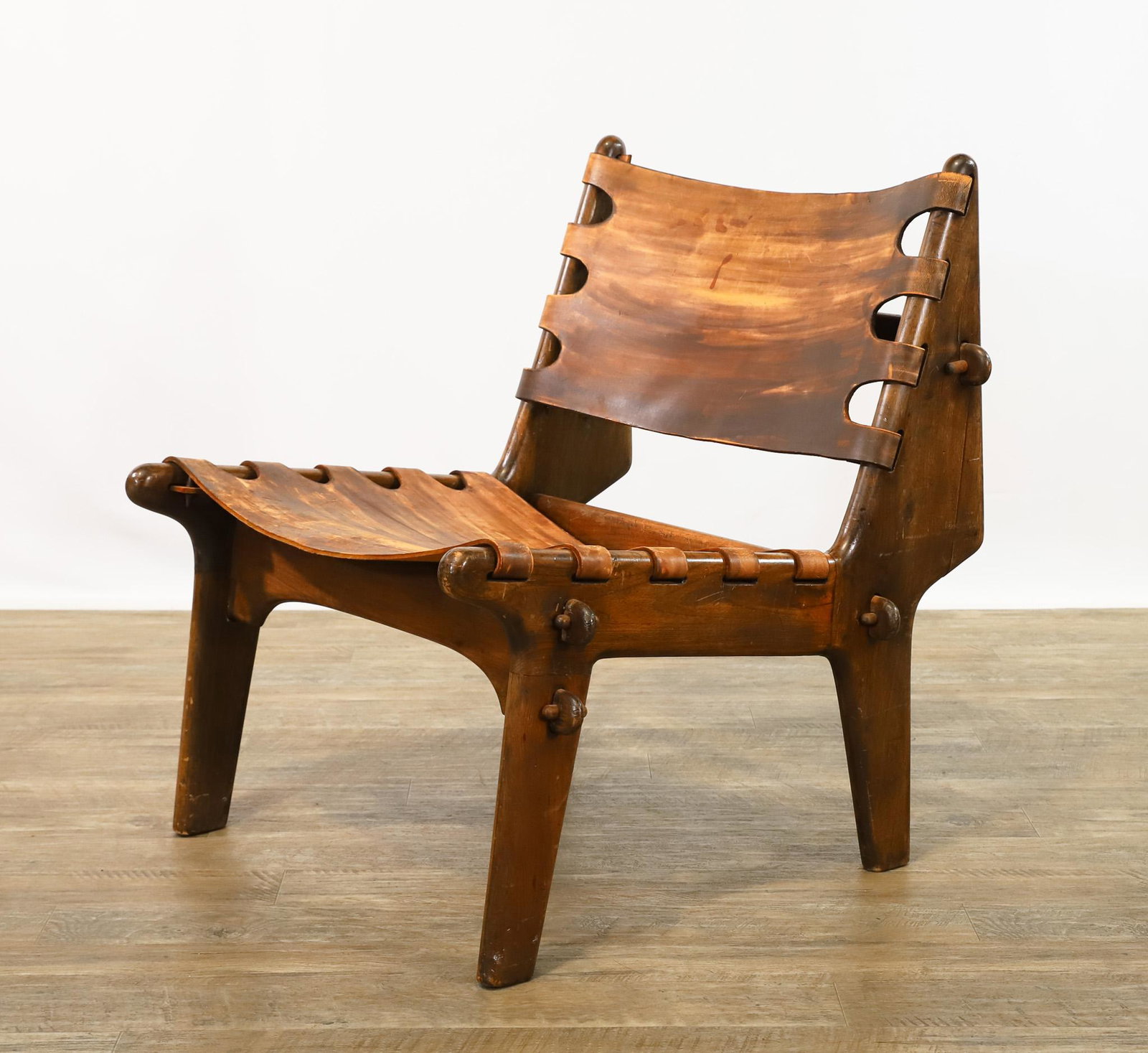 Angel Pazmino for Muebles de Estilo Cotacachi Lounge Chair: Black walnut and leather, with mortise and tenon construction, made in Ecuador, unmarked. Two pegs are missing. 29"h x 25"w x 27"d, seat height 15"