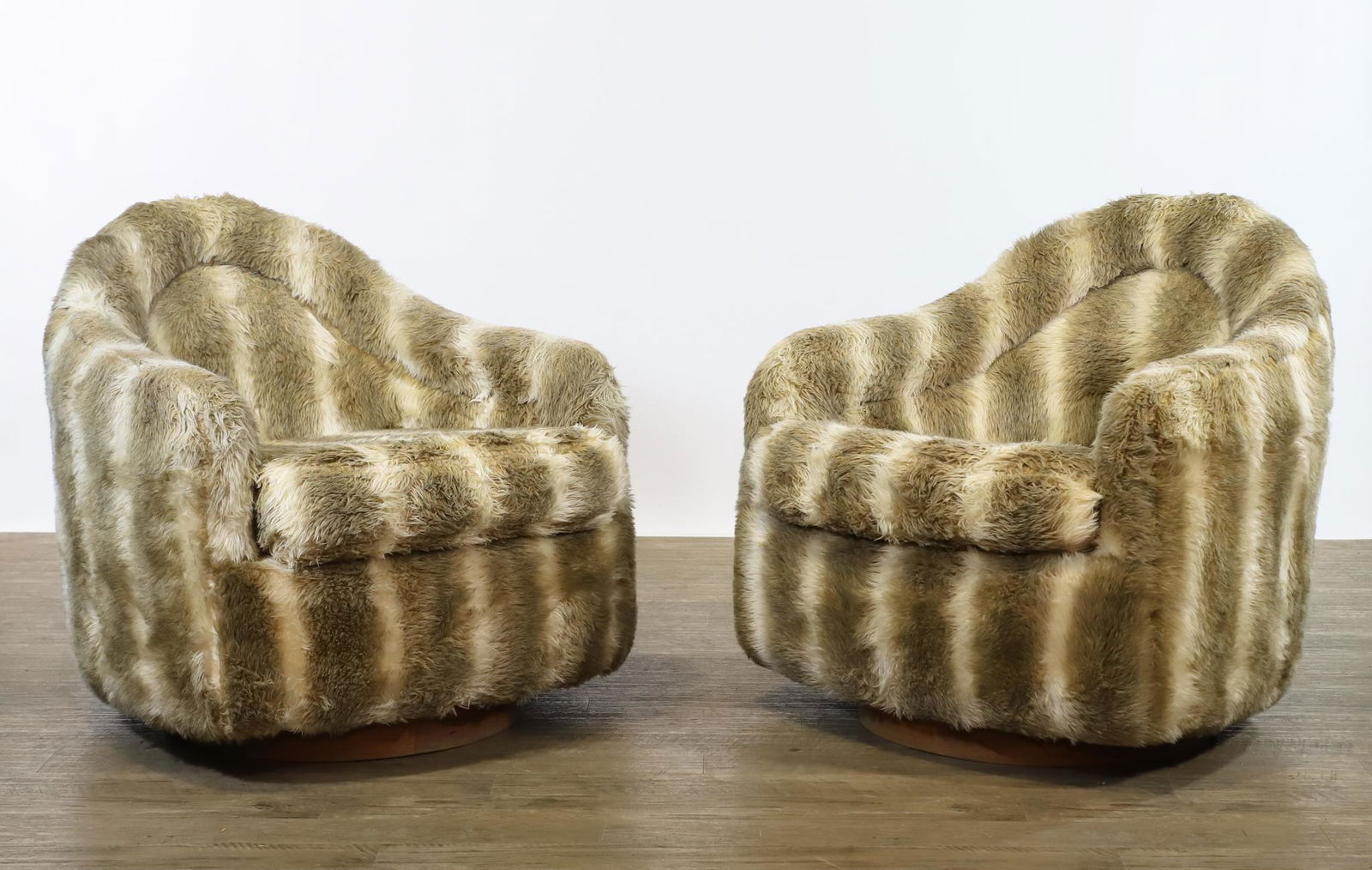 Adrian Pearsall Tilt and Swivel Club Chairs: Tilt and swivel pair of club chairs on teak drums, with shag mohair upholstery. Unmarked. One chair has an approximately 4" gash to the center top upholstery and cushioning. 30"h x 28"w x 27"d, seat h