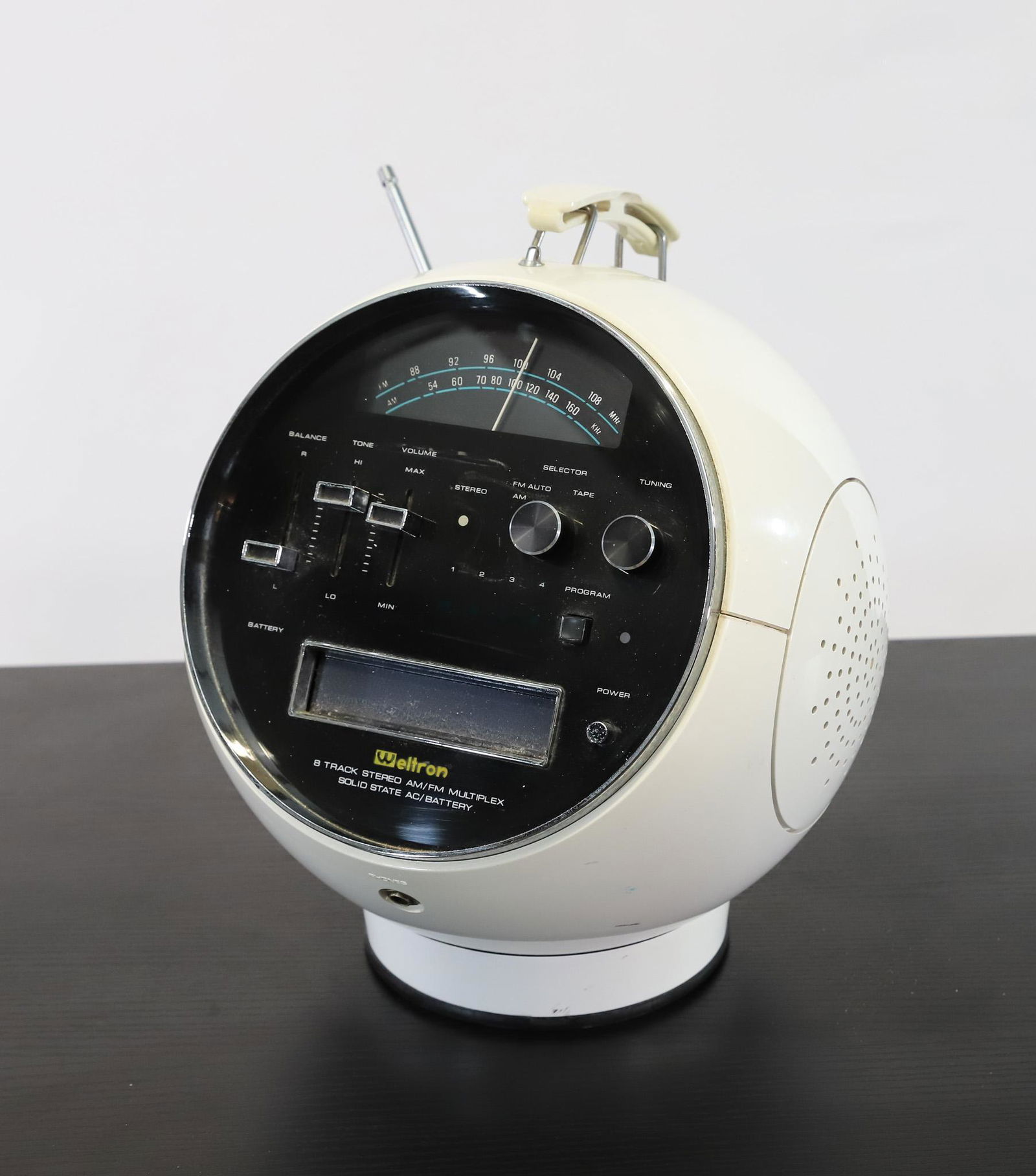 Weltron 2001 Space Ball Radio / 8-Track Player: White plastic portable radio / 8-track player, model 2001. Includes assorted 8-track tapes (30+). The tuner is in working condition, but the functionality of the tape player and tapes is unknown. Some