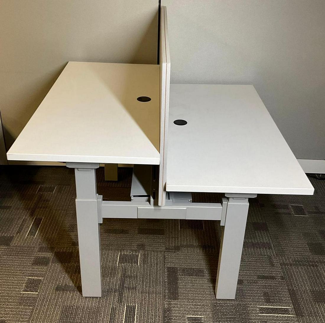 Double Sided Adjustable Desk: Double Sided Adjustable Height Desk, with privacy panels, 46.5"w x 46"d x 46.5"h overall. Height adjusts from 27.75"h to 40.5"h. Working.This lot is not eligible for Alderfer transport. Buyer is respo
