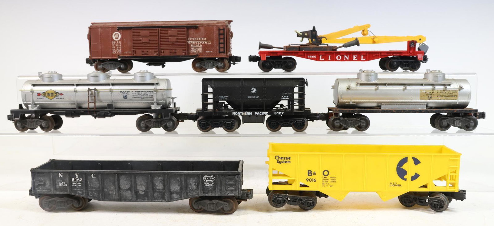 Lionel Train Cars: O gauge, 3-rail Derrick flatcar #6660, Northern Pacific hopper #6127, Sunoco tanker, Automobiles boxcar #2758, NYC gondola #6462 and B&O Chessie System hopper #9016.