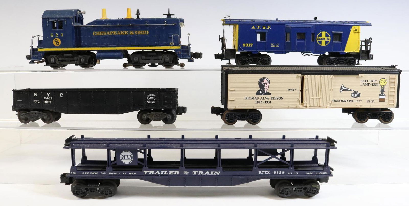 Lionel Diesel Engine and Cars: O gauge, 3-rail Chesapeake & Ohio diesel Switcher engine #624, N&W trailer train car #9125, ATSF bay window caboose #9317, NYC gondola #6462 with gravel load and Thomas Edison boxcar #19507.