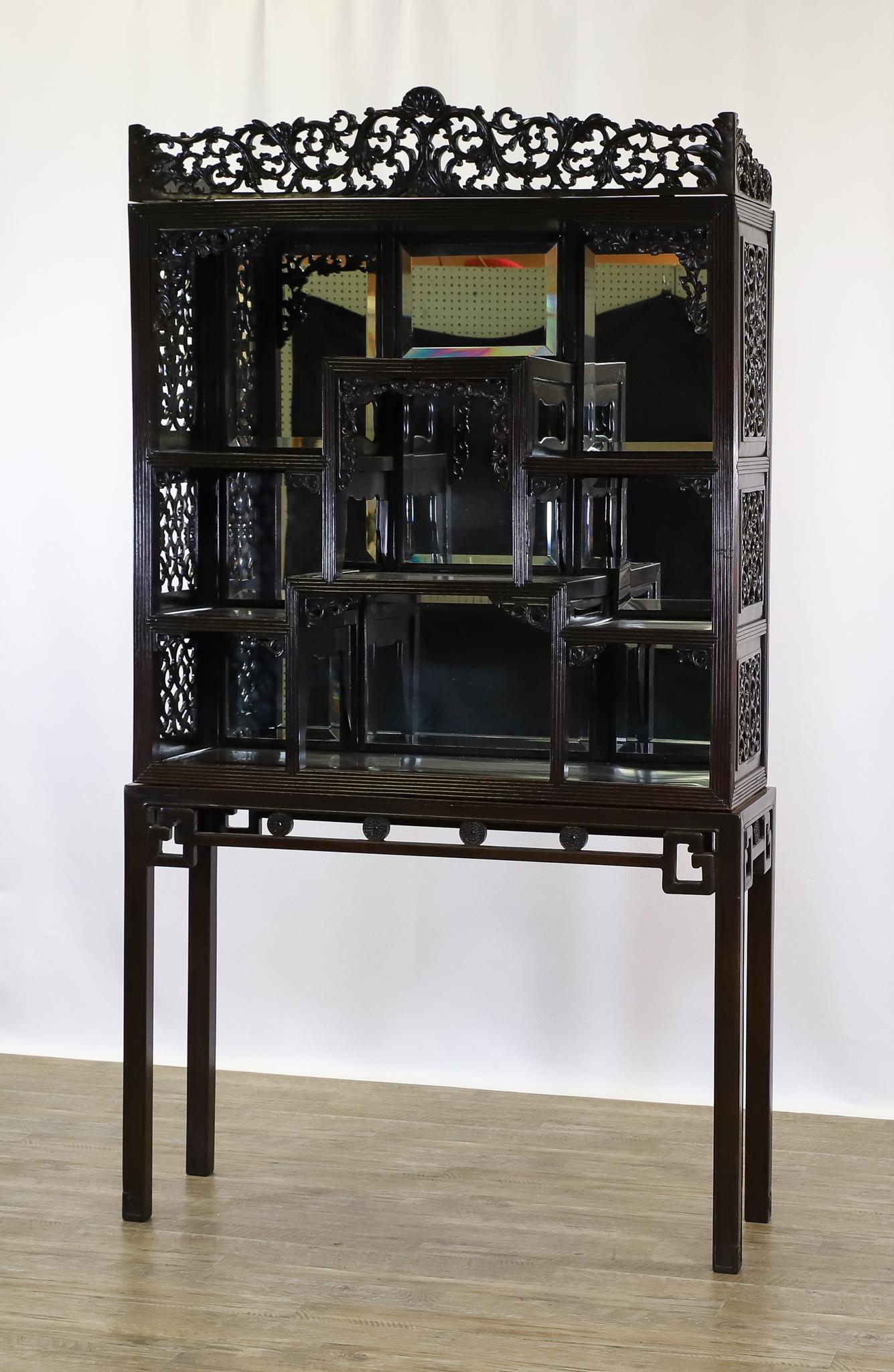 Carved Chinese Etagere-on-Stand: Marriage with the top having pierced carved floral and foliate decoration, a bevel mirrored back and molded edges, on an altar table base with pierced and decorative frieze on straight molded legs. Th