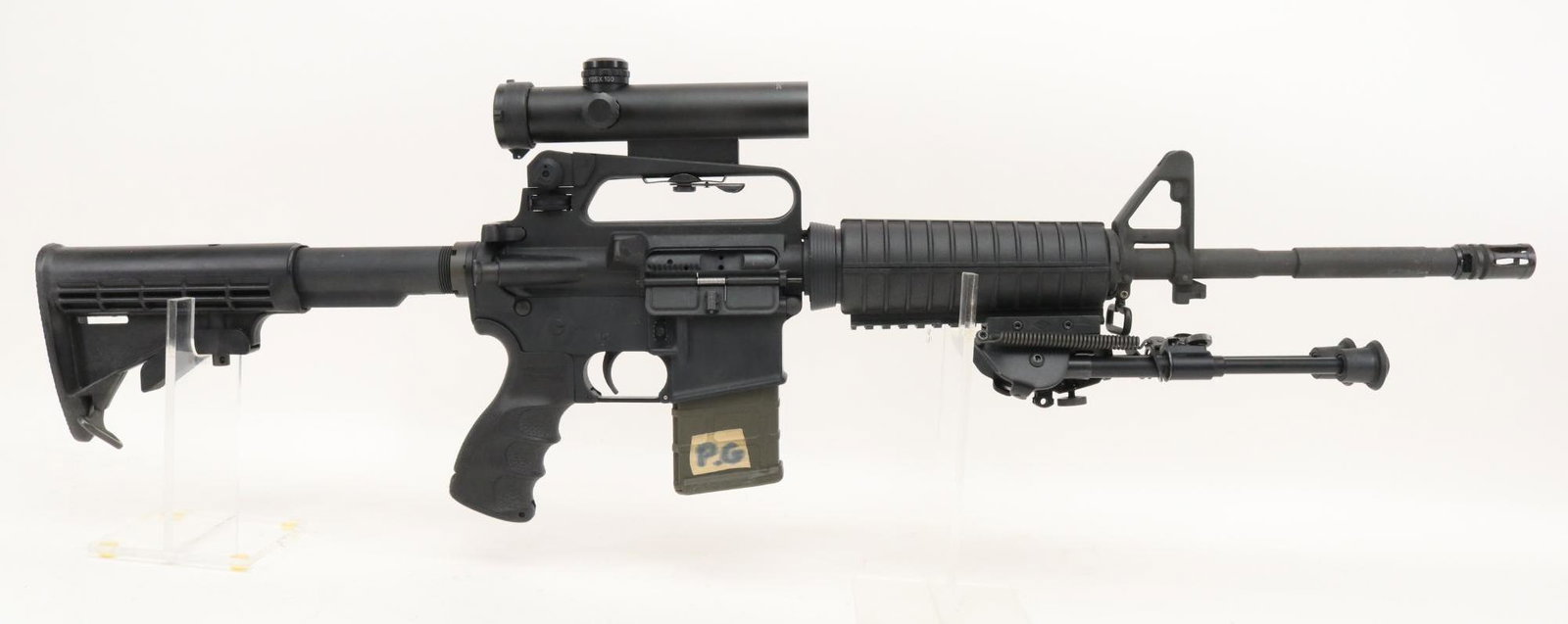 Bushmaster XM-15-E2S Semi Automatic Rifle: 223/5.56, 16 1/2" bbl, SN BFI436411. Matte black finish shows average handling, good bore, A2 front sight and A2 rear sight/carry handle with quick detachable 4x mil-dot scope (Colt clone) with clear 