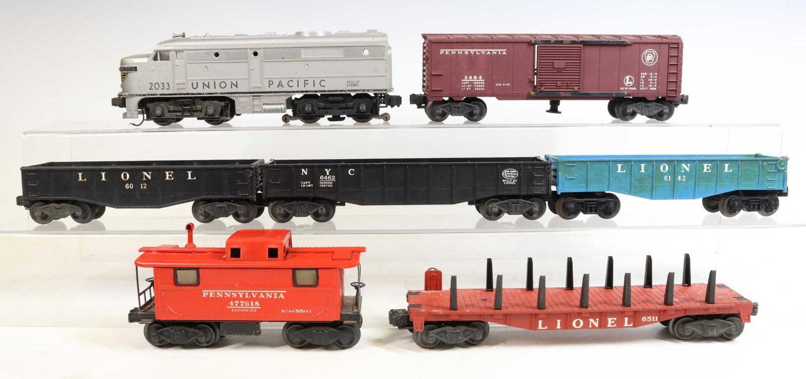 Lionel Train Cars: O gauge, 3-rail Union Pacific diesel #2033, PRR boxcar #3484, (3) gondola cars, caboose and pipe flatcar #6511.