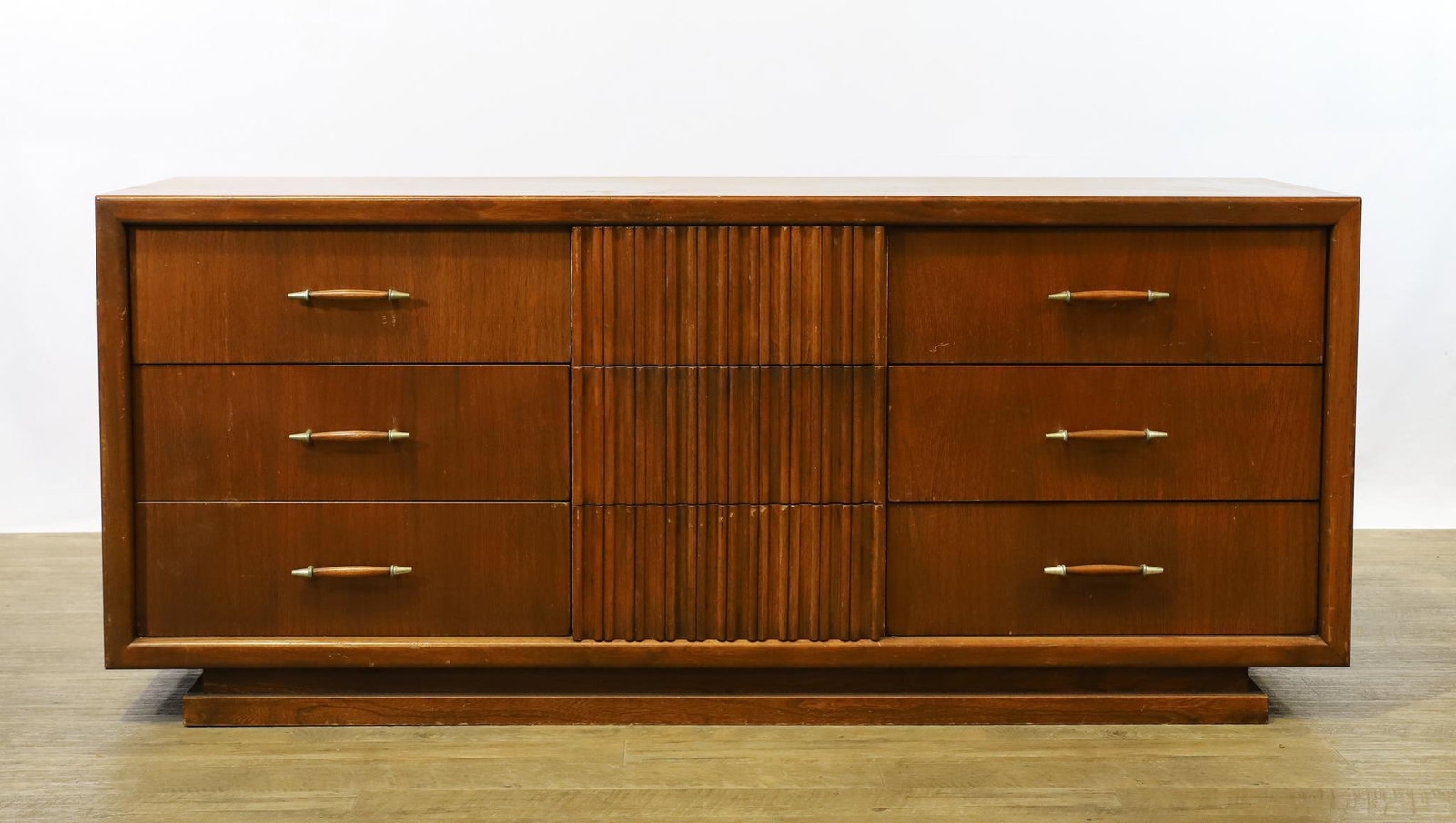 Exclusively Yours by Big Rapids Dresser: Elm low dresser with six drawers flanking three fluted drawers. 27.75"h x 65"w x 20"d