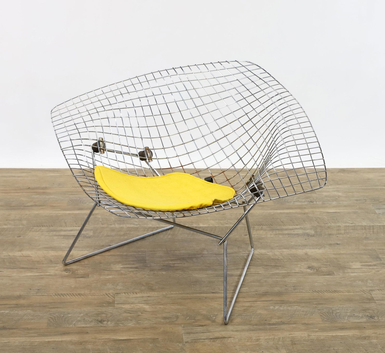 Harry Bertoia for Knoll Large Diamond Chair: Chrome finished steel wire chair with sunflower yellow seat pad. Unmarked. 27"h x 44"w 32"d, seat height 15"