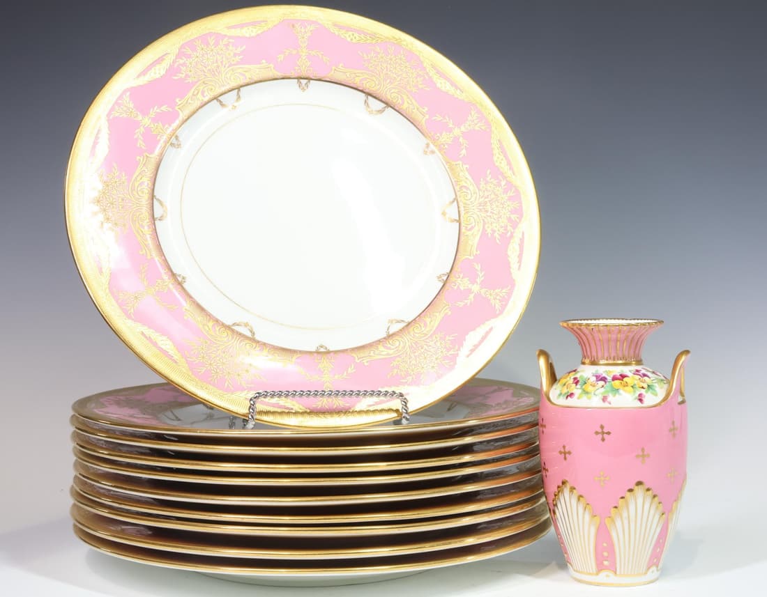 Minton Raised Gold and Pink Dinner Plates and Vase: Raised gold and pink dinner plates decorated with flowers and swag throughout. Set of (10), 11.25"w. Also includes a small vase manufactured for Bailey, Banks and Biddle by Minton, 5.5"h x 3"w