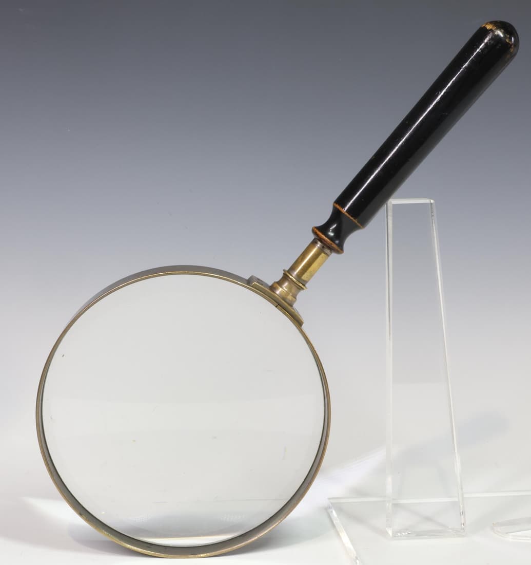 Oversized Magnifying Glass: Oversized magnifying glass with ebonized handle and brass fittings. 14.5"h x 6.5"w