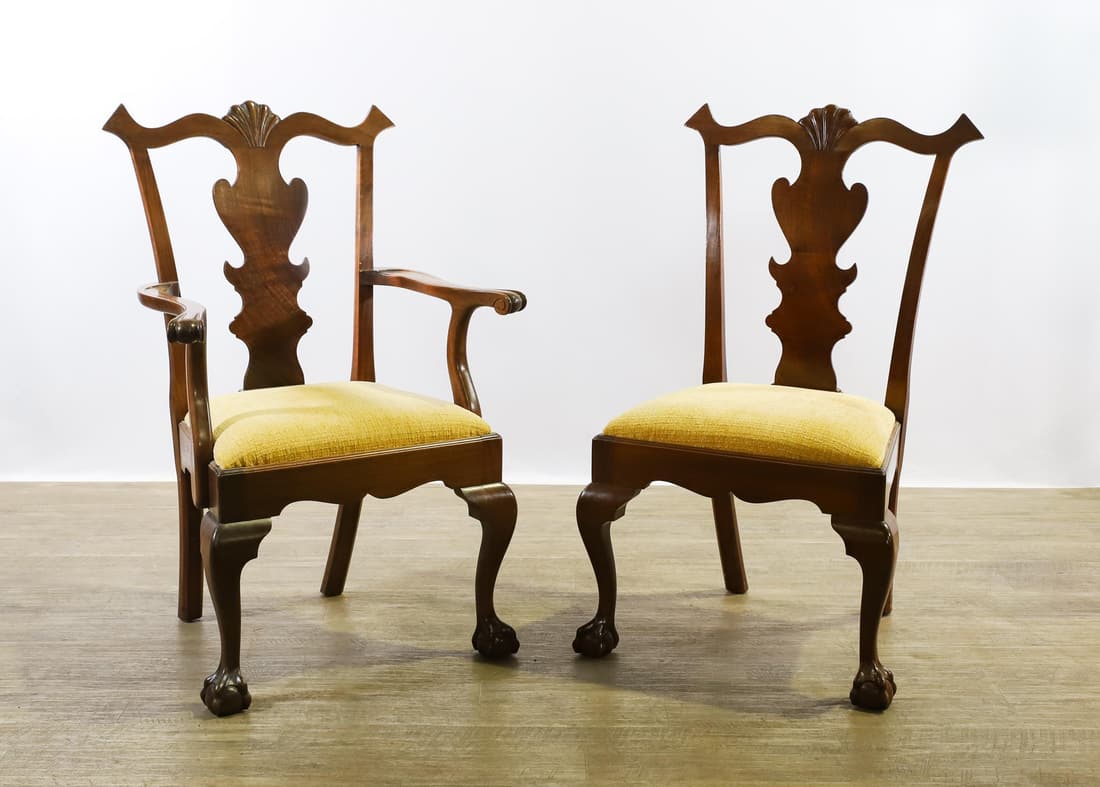 Chippendale Style Dining Chairs: Mahogany with a scrolled shell carved crest and ears, vasiform splat, beige textured upholstery, shaped apron, cabriole legs on claw and ball feet. (2) Chairs. Arm chair 39"h x 27"w x 21"d, 18" seat h