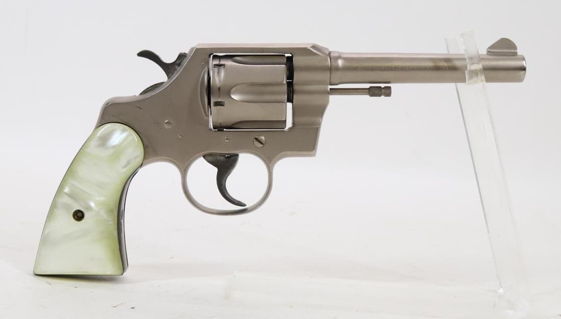Colt Official Police Double Action Revolver: 38 Special, 5" bbl, SN 859877. 95% matte nickel finish shows areas of loss on back strap with thinning on crisp edges and average cylinder drag line, good bore, plastic pearl grips with black line spa