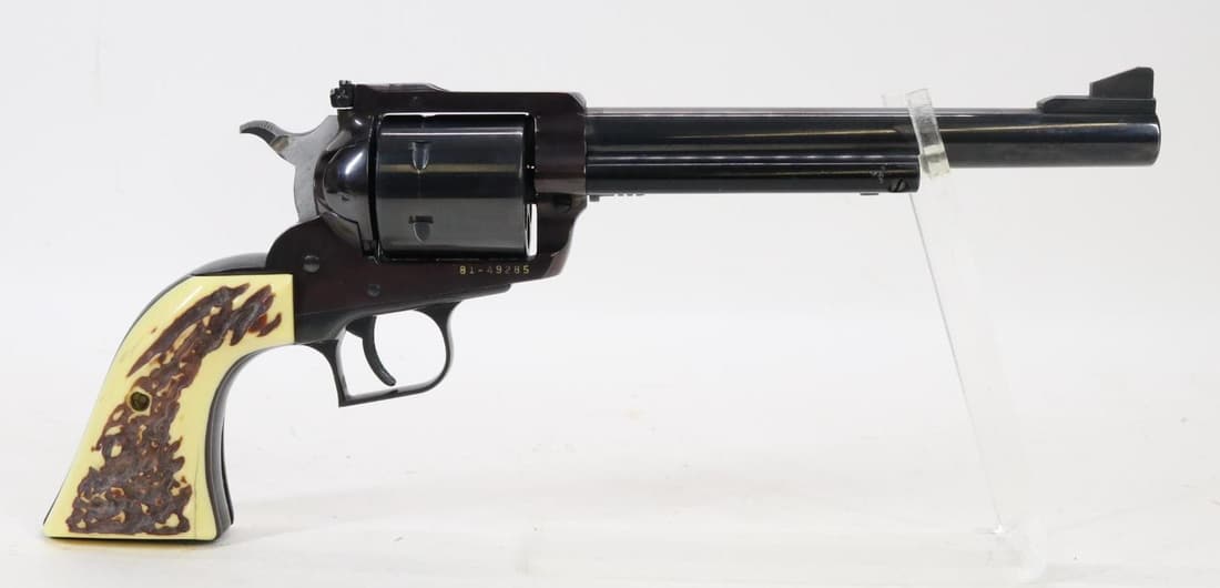 Ruger New Model Super Blackhawk Single Action Revolver: 44 Rem mag, 7 1/2" bbl, SN 81-49285. 95% blue finish shows average handling with the frame turning a plum color and loss on bottom of grip strap, average cylinder drag line, good bore, adjustable rear