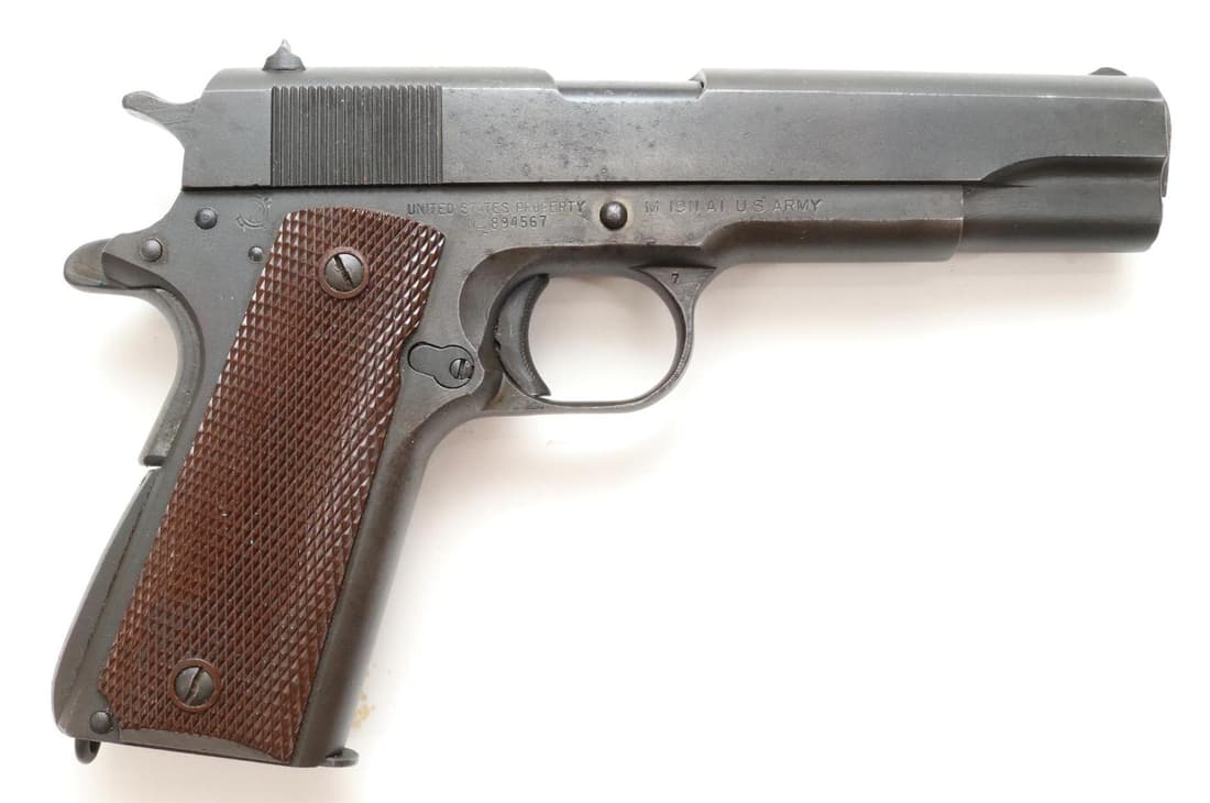 Ithaca 1911A1 US Army Semi Automatic Pistol: 45 ACP, 5" bbl, SN 894567. 85% gray parkerized ? finish shows thin with spotting on sides of frame and slide, good bore, left side of frame is marked with FJA (Frank Atwood) and a small P by mag relea