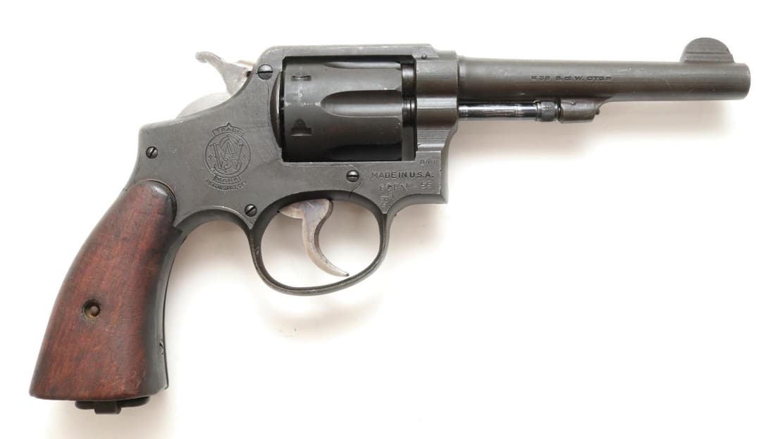 Rare Smith & Wesson/Vega Australia Marked US Property M&P 38 Double Action Revolver: 38 S&W, 5" bbl, SN 953132. 98% dark gray parkerized finish shows light average handling, good bore, top strap marked UNITED STATES PROPERTY, right side of frame marked with D Arrow D (Australia accept