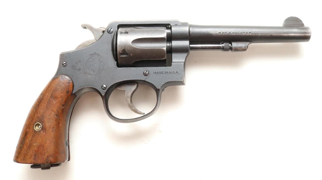 Smith & Wesson M&P Victory Double Action Revolver: 38 S&W, 5" bbl, SN V 206331. 85% parkerized finish shows average handling with loss on sides of muzzle, grip straps and cylinder, good bore, small half moon front sight has rough top edge, steel lanya
