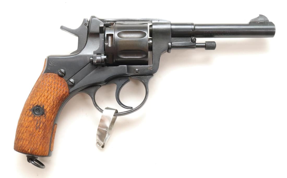 Russian Tula/CAI 1895 Nagant Double Action Revolver: 7.62x38R, 4 1/2" bbl, SN LM907. 98% black finish shows light handling, left side of frame dated 1938 with Tula arsenal star and arrow, steel lanyard ring on butt, checkered wood grips show light handl