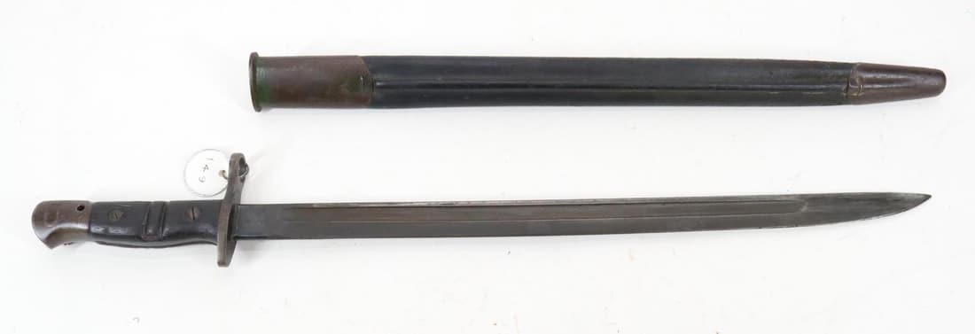 Remington M1917 Sword Bayonet And Scabbard: with 17" blade, fullers on both sides, blade marked 1917 over Remington in a circle on 1 side of ricasso and flaming bomb over US, a faint X (bend test proof) and eagle head (acceptance proof) over 20