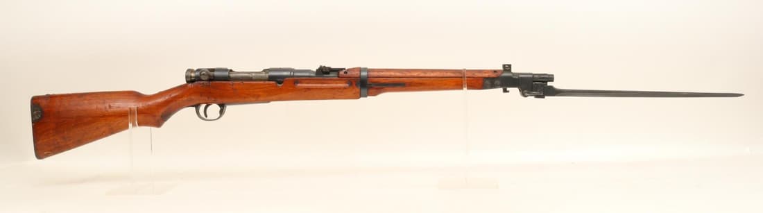 Japanese Tokyo/Kokura Type 44 Arisaka Carbine Bolt Action Rifle: 6.5 Jap, 18 1/2" bbl, SN 34071. 98% gray finish shows light handling, fair bore, good mum, flip up rear ladder sight and guarded front, under folding bayonet with 13 3/4" blade mounted on forearm nose