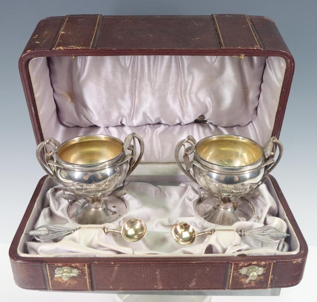 George Sharp Coin Silver Aesthetic Salt Set: American coin silver, mid 19th C., pair of open master salts and spoons with caittail motif, gold washed interiors and bowls, with early George Sharp marks. The salts are monogrammed. Includes origina