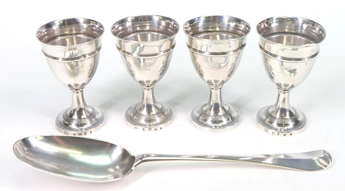 British Georgian Sterling Silver Tablewares: George I and III sterling silver pieces. Tablespoon, London, 1719, by Samuel Hitchcock, monogrammed, 8". Set of (4) egg cups, Birmingham, 1795, by Matthew Boulton, with family crest, 3"h. 6.11 ozt