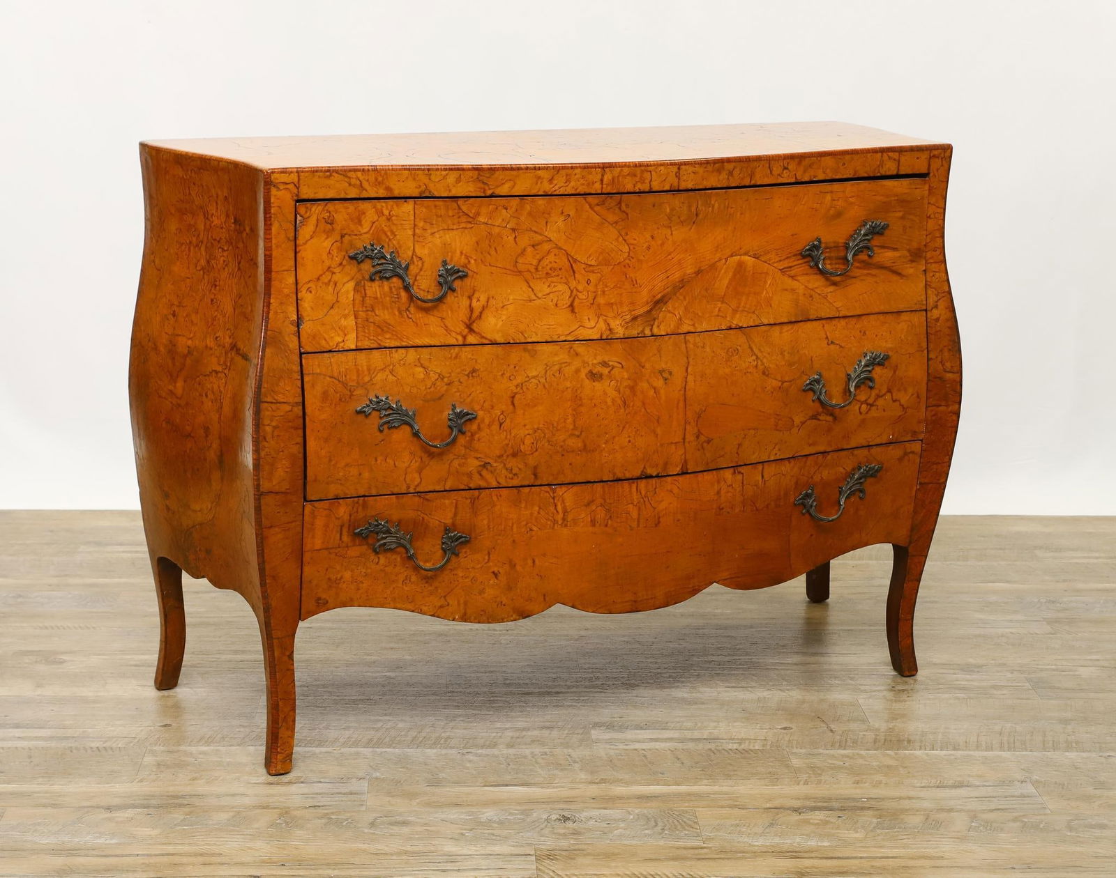 Italian Burl-Olive Veneered Bombe Commode: Serpentine top, three drawers with the bottom having a shaped frieze, on cabriole legs. 33"h x 47"w x 18"d