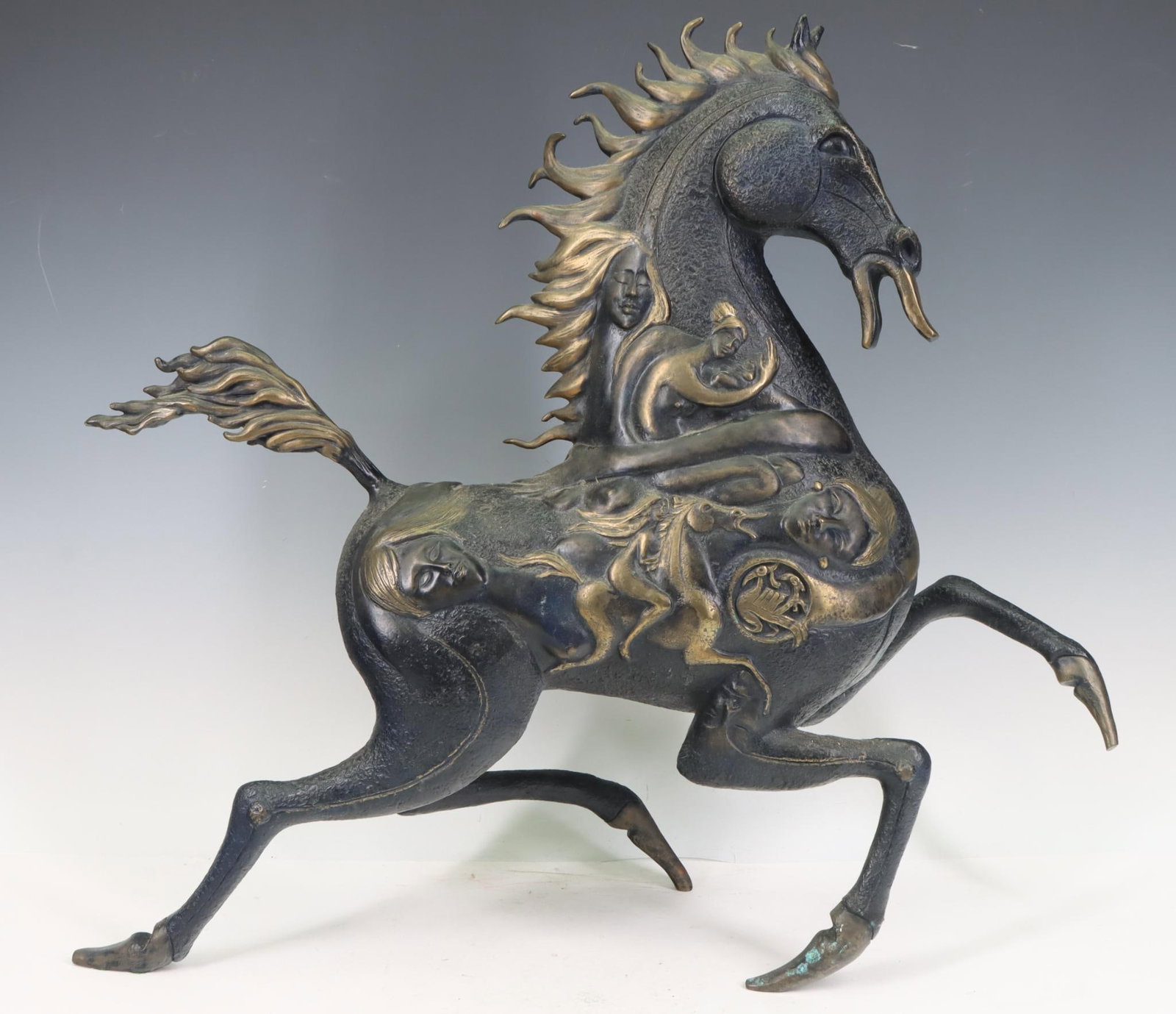 Jiang Tiefeng (B. 1938): Bronze sculpture of a trotting horse decorated with surreal figures, birds, and Chinese symbols, impressed "Fingerhut" to the underside, numbered 102 of 225. 17.5”h x 19.5”w