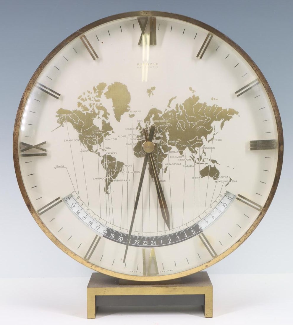 Kienzle World Time Clock: German Art Deco style desk clock in the form of a map of the world set in a brass case, with time zones, designed by Heinrich Moeller for Kienzle. Battery operated. The mechanism needs adjustment, bec
