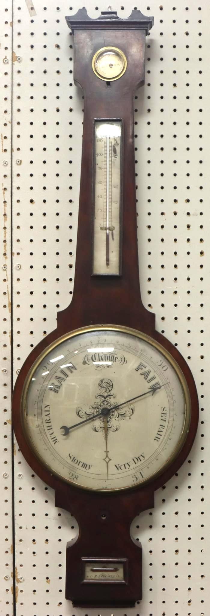 English Banjo Barometer: Banjo/Wheel barometer. Level indicator marked "Manchester", gauges include hygrometer, temperature and barometer. 44"h x 14"w
