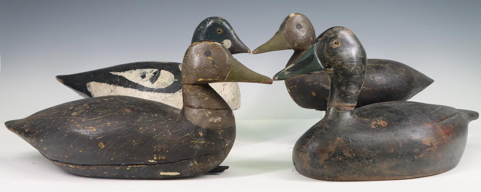 Antique Duck Decoys: Antique duck decoys (4), hand painted, wood, 3 are weighted, all show signs of wear from use. Largest 8.5"h x 16.25"w x 7"d