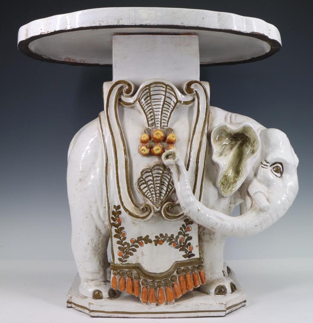 Italian Majolica Elephant Plant Stand: Glazed pottery stand, the base in the form of an elephant, the removable top with Neoclassical motif, made in Italy for Meiselman Imports. 20"h x 19"w x 14.75"d