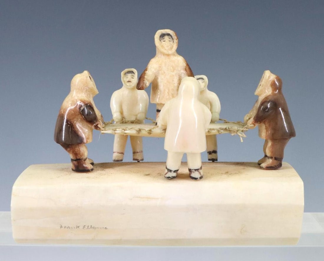 Frank Ellanna (20th C.) Inuit Sculpture: Walrus tusk sculpture with applied figures, signed. 4.75”h x 6”w x 2.75”d
