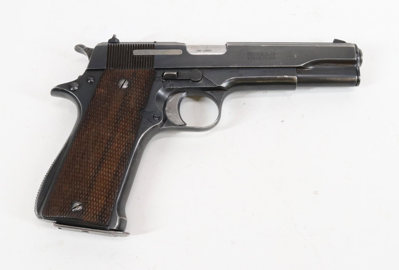 Star/IAC Model Super B Semi Automatic Pistol: 9mm Largo, 5" bbl, SN 332712. 85% blue finish shows general thinning with loss on most edges, good bore, checkered wood grips show average handling, 1-8 rnd magazine. Good condition. 23-1051 C&R NOTE: