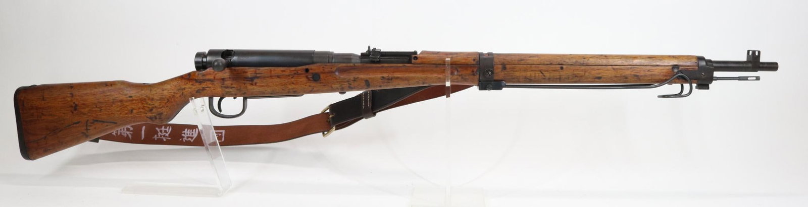 Japanese Nagoya Type 99 Second Series Arisaka Bolt Action Rifle: 7.7 Jap, 26" bbl, SN 89827. Dark grey patina, good bore, flip up rear ladder sight with good anti aircraft wings, guarded front sight, fold down bipod, sliding dust cover, mum has been ground but is s