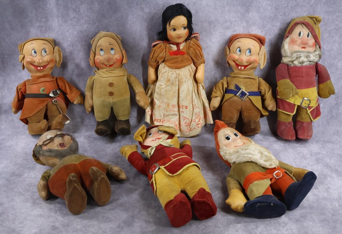 CLOTH DOLL(S).: LOT. Group of Walt Disney's "Snow White" with "Seven Dwarfs". This is a mismatched set from the 1930's. All have mask faces and cloth bodies. 16" Snow White - black mohair wig, no shoes. Dwarfs range