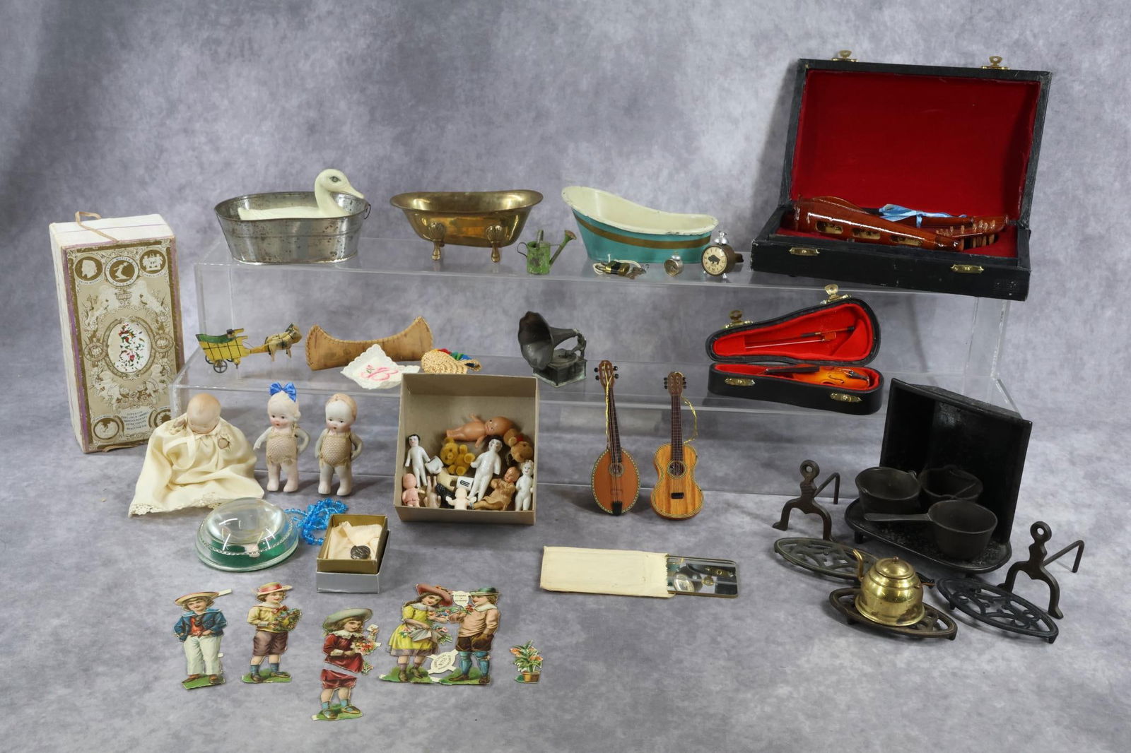 MINIATURES: LOT of antique/vintage items. Dolls - all bisques, Frozen Charlies, dollhouse, Kewpie, Kewpie paper weight, misc. Larger scale musical instruments. Larger Henry Matier & Co. Belfast handkerchief box,