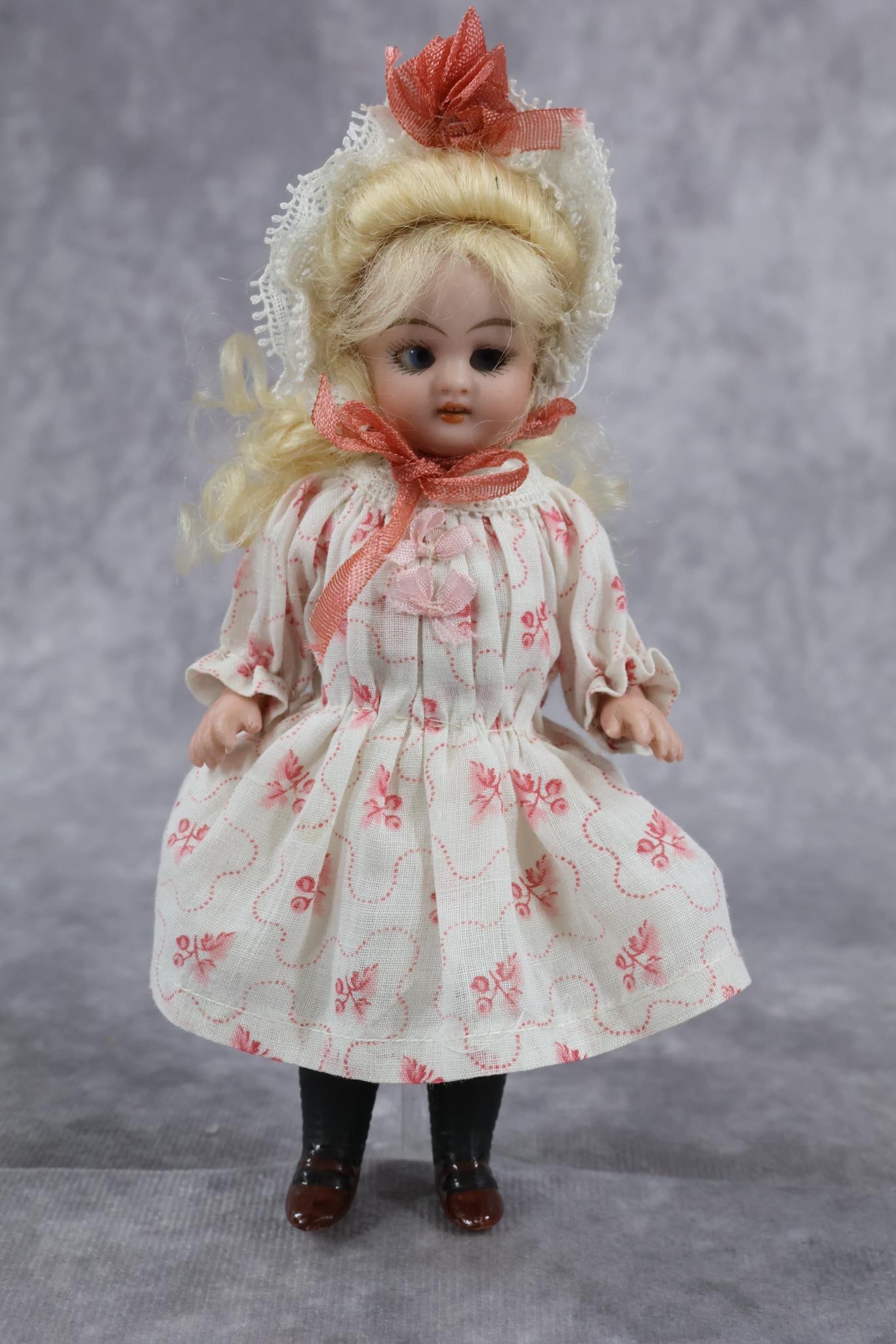 GERMAN ALL BISQUE DOLL(S).: 5" "0" Doll with swivel head. Blue sleep eyes, open mouth, pale blonde curly mohair wig. 5 Pc. body with painted long black stockings, brown shoes. Attractively redressed. Condition: nothing observed