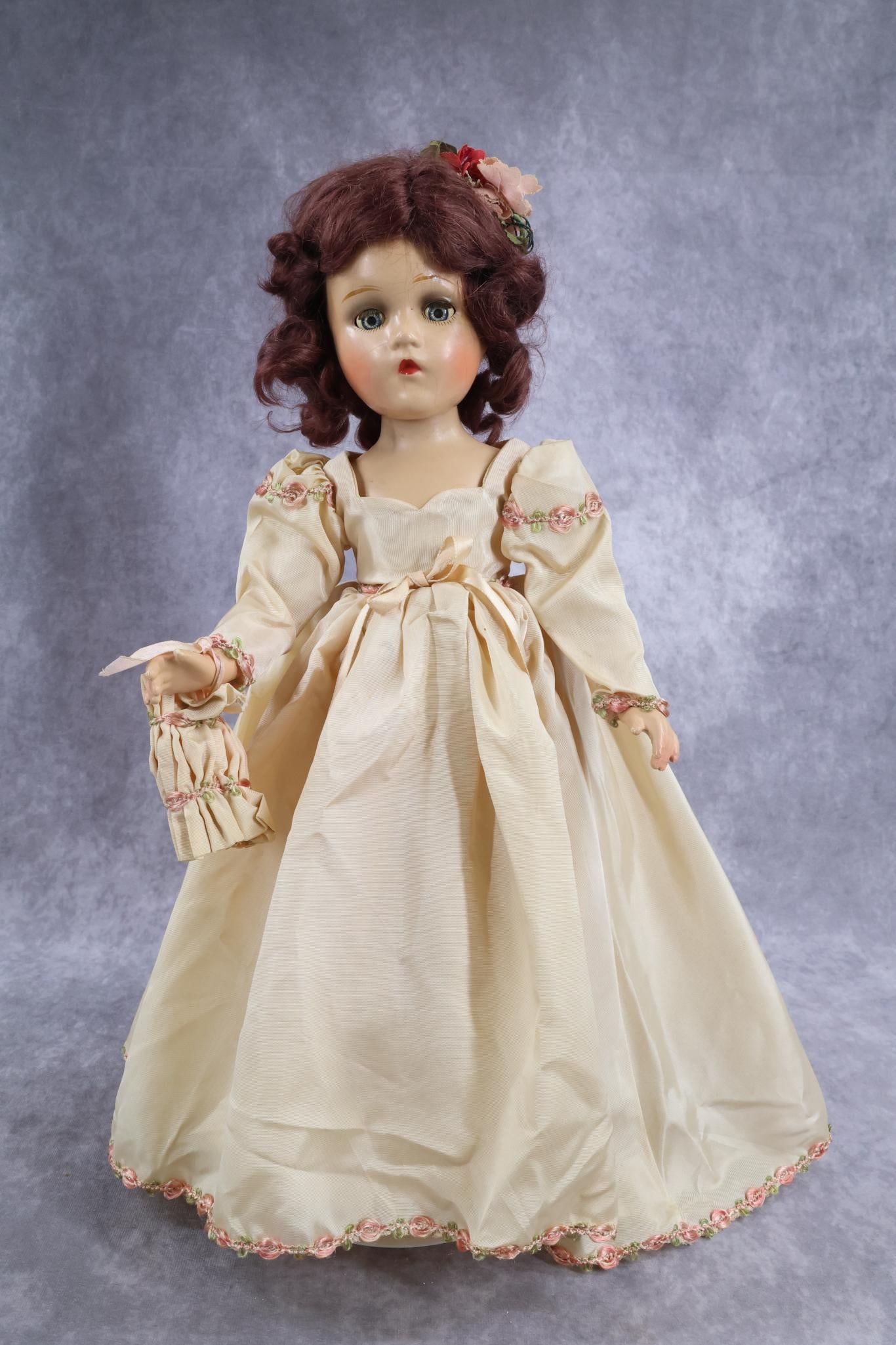 COMPOSITION DOLL(S).: 18" 1945 All original tagged MADAME ALEXANDER "Bridesmaid" with the Wendy Ann face. Reddish-brown mohair wig. Dressed in tagged taffeta gown with matching muff. Attached petticoat matches panties. Ivo